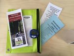 Photo of bag with informational pamphlets & pedometer